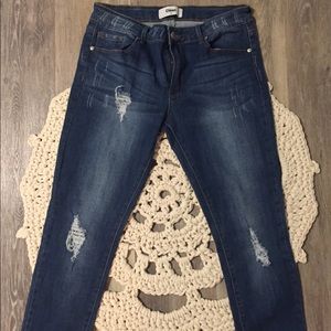 Mid rise distressed skinny jeans.